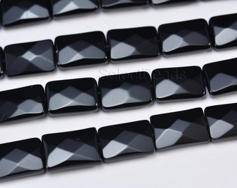 May include: Black faceted rectangular gemstone beads. The beads have a polished, shiny finish.
