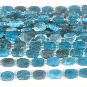 May include: A strand of blue apatite beads, each bead is rectangular and faceted. The beads are strung on a silver wire.