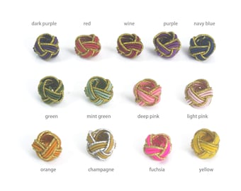 May include: A collection of decorative knot-shaped ornaments in various colors, including dark purple, red, wine, purple, and navy blue. Additional colors are green, mint green, deep pink, light pink, orange, champagne, fuchsia, and yellow.