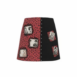 May include: A-line skirt with a split design. One side features a red leopard print, while the other is solid black. The leopard print side has framed black and white images. The skirt fastens with a row of buttons.