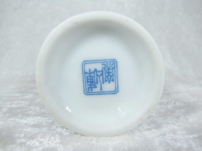 May include: White ceramic plate with a blue square mark containing Chinese characters.