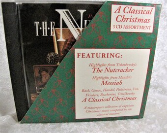 May include: A Classical Christmas 3 CD assortment. The CD case is black with a green and red decorative cover. The cover features text that reads "A Classical Christmas" and "3 CD ASSORTMENT". The cover also lists highlights from Tchaikovsky's The Nutcracker and Handel's Messiah.