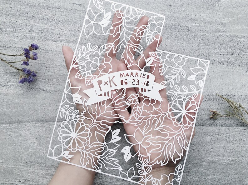 May include: White paper cut-out of the state of Utah with a floral design. A banner across the middle reads "P*K Married 06-23-18".