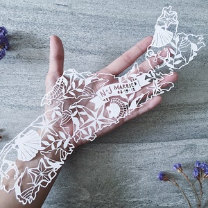 May include: White paper cut-out of the state of Massachusetts with a banner that reads "N+J Married 06-19-18" and various nautical and floral designs.