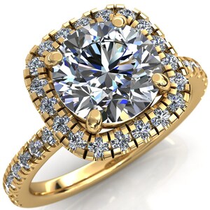 May include: A gold ring with a large, round, clear diamond center stone surrounded by a halo of smaller diamonds. The band is also set with smaller diamonds.