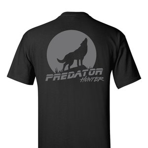 May include: Black t-shirt with a gray wolf howling at the moon graphic and the text "PREDATOR HUNTER" printed on the back.