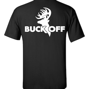 May include: Black t-shirt with a white graphic of a deer head and the words "BUCK OFF" in bold, capital letters. The deer head is stylized with prominent antlers. The shirt is a classic crew neck style.