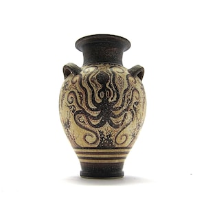 May include: A small, ceramic vase with a brown and white design featuring an octopus. The vase has two handles and a rounded body.