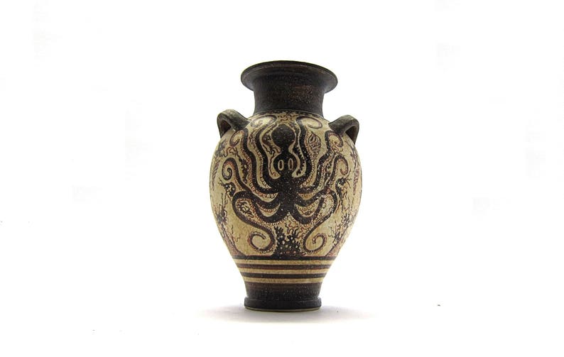 May include: A small, brown and white ceramic vase with a design of an octopus with tentacles. The vase has a round body and a narrow neck.