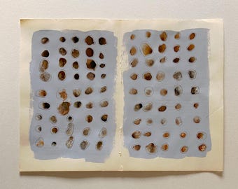 May include: Abstract artwork on aged paper. Two light blue rectangular shapes are filled with numerous brown, tan, and grey organic shapes. The shapes are outlined in white, creating a contrast against the blue background. The paper has a yellowed, vintage appearance.