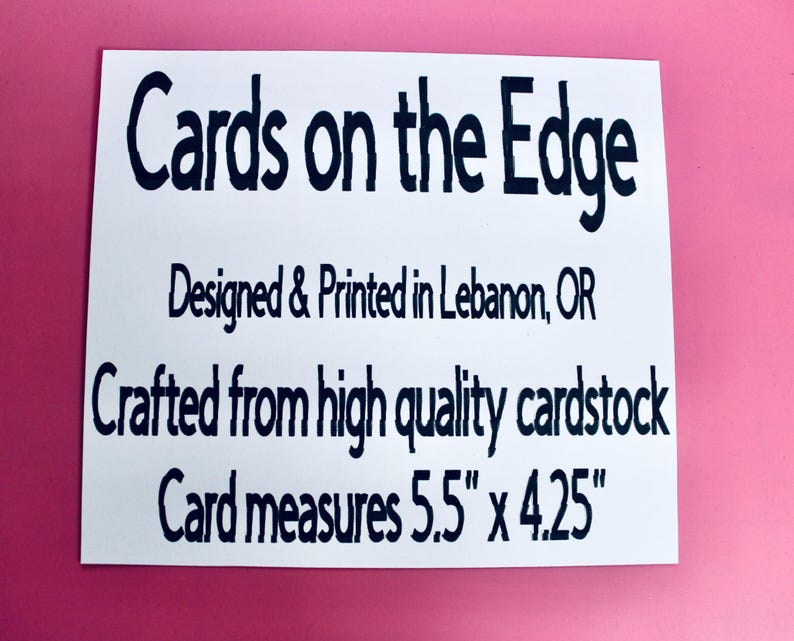 May include: White rectangular card with black text that reads "Cards on the Edge." The card is designed and printed in Lebanon, OR, and crafted from high-quality cardstock. The card measures 5.5" x 4.25". The background is pink.