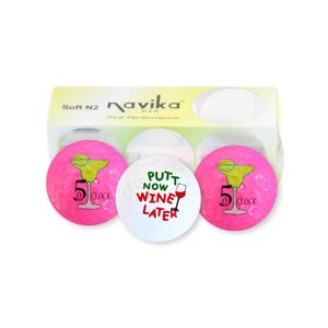 May include: A package of golf balls with a margarita and the text "5 o'clock" printed on pink balls. One white ball has the text "Putt Now Wine Later". The box reads "Navika USA".