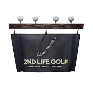 May include: A golf-themed display featuring four golf balls on tees, mounted on a dark wooden plank. Below, a black banner displays a golf club graphic and the text "2ND LIFE GOLF, GIVING OLD CLUBS A SECOND CHANCE."
