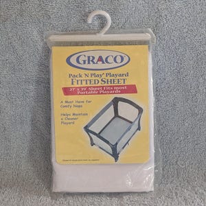 May include: A white fitted sheet for a Graco Pack 'N Play Playard. The sheet is 27 inches by 39 inches and fits most portable playards. The sheet is a must-have for comfy naps and helps maintain a cleaner playard.