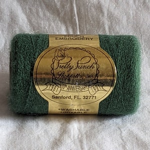 May include: A spool of green punch embroidery thread with a gold label that reads "Pretty Punch Shoppett's Inc. 1981 10th Anniversary 1991 Sanford, FL 32771 -Washable -Dryable"