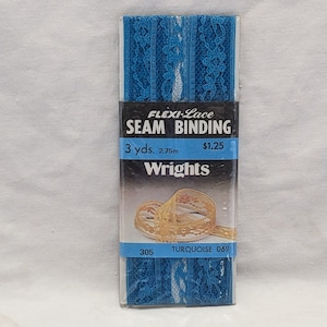 May include: A package of turquoise blue lace trim for sewing. The package is labeled "Flexi-Lace Seam Binding" and "Wrights". It contains 3 yards (2.75 meters) of trim and costs $1.25.