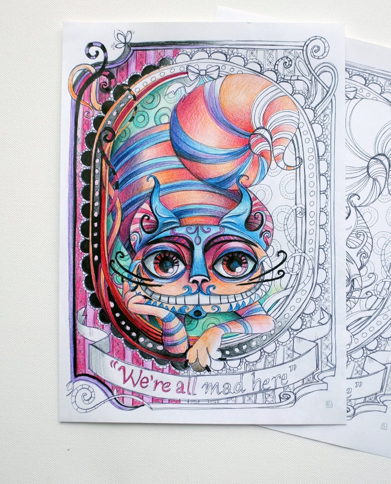 May include: A colorful illustration of the Cheshire Cat from Alice in Wonderland. The cat is smiling with a wide grin and has a blue and orange striped hat. The text "We're all mad here" is written on a banner below the cat.