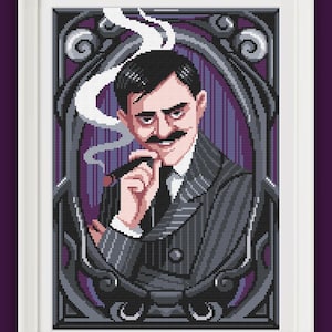 May include: A framed cross-stitch portrait of a man in a pinstripe suit, holding a cigar. The artwork features a dark color palette with shades of gray, purple, and black. The man has a mustache and is framed by an ornate border.