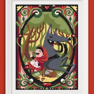 May include: A cross-stitch pattern featuring a red-hooded girl and a wolf in a forest setting. The pattern is framed in a white frame and has a colorful, intricate design.