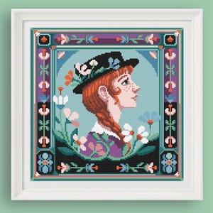May include: A cross-stitch pattern depicting a portrait of a person with red hair wearing a black hat and a purple dress. The person is surrounded by flowers and greenery. The pattern is framed in a colourful border.