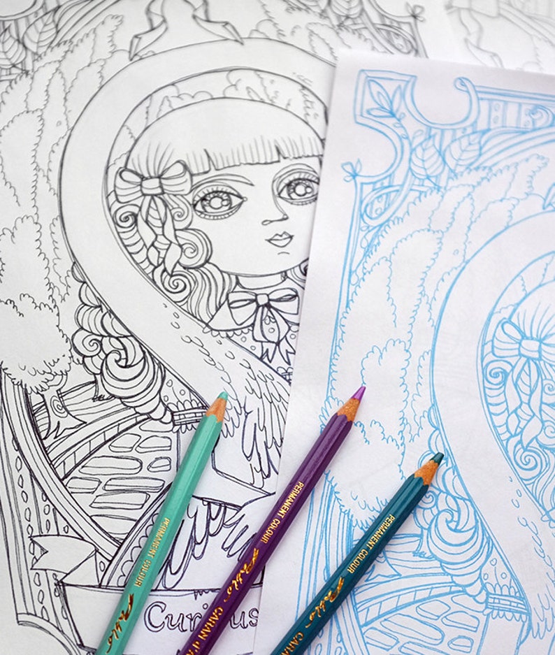 May include: Two coloring book pages with intricate line drawings of a girl with wings and a floral design. Three colored pencils are laying on top of the pages, one teal, one purple, and one blue.