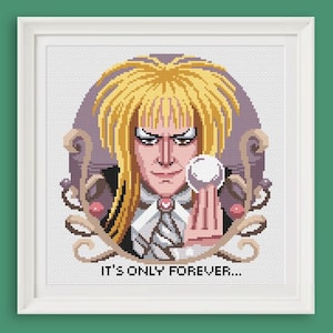 May include: A cross-stitch pattern featuring a portrait of a character with long blonde hair, holding a white orb. The character is wearing a black suit with a white shirt and a white bow tie. The background is a purple and white swirl design. The text "It's only forever..." is below the image.