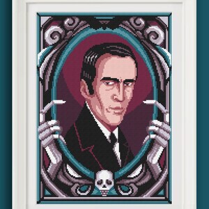 May include: Cross-stitch portrait of a man in a black suit, framed in white. The artwork features a teal and purple border with skeletal hands and a skull. The man has dark hair and a stern expression.