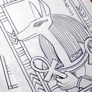 May include: Black and white line drawing of an Egyptian god Anubis with a staff and an ankh symbol. The image is framed with a decorative border.