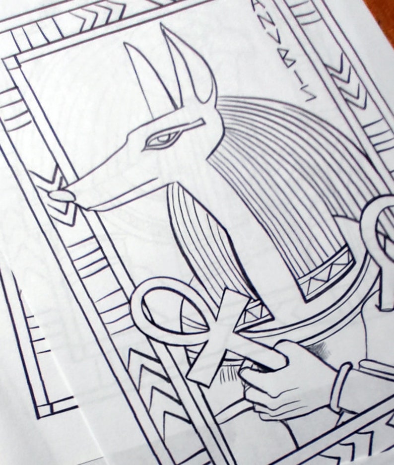 May include: Black and white line drawing of an Egyptian god Anubis with a staff and an ankh symbol. The image is framed with a decorative border.