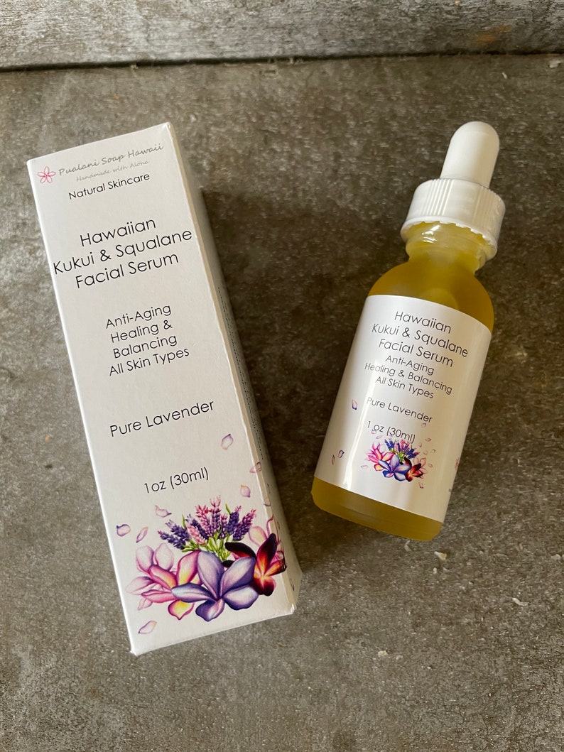 May include: A bottle and box of Hawaiian Kukui & Squalane Facial Serum. The serum is labelled "Pure Lavender" and is for anti-aging, healing, and balancing all skin types. The box and bottle feature floral designs and the product is 30ml.