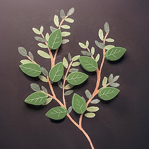 May include: A green leaf design with a branch and leaves on a black background.