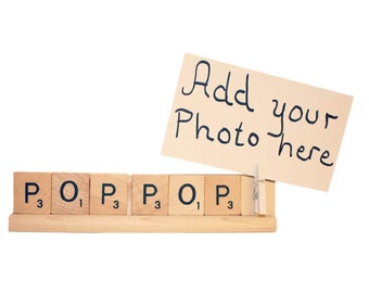 May include: Wooden letter tiles spelling "POP" with a small card attached with a clothespin that says "Add your photo here".