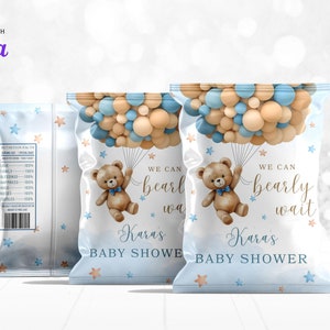May include: Blue and beige baby shower favor bags with a teddy bear holding balloons. The bags have the text "We can barely wait" and "Karas Baby Shower".