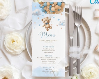 May include: A blue and white baby shower menu featuring a teddy bear holding balloons. The menu includes starters, mains, and desserts. The text on the menu reads "Kara's Baby Shower 08/03/20XX".
