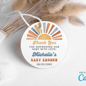 May include: Round thank you tag with a sunset design in shades of orange, yellow, blue, and white. The text reads "Thank You for showering our baby with love! Michelle's Baby Shower 08/03/20XX".