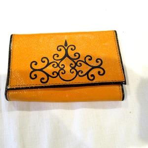 Princess Gardner gold leather key case with black scroll work, c. 1970s