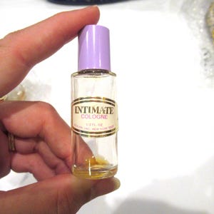 Revlon Intimate miniature perfume bottle, lavender lid