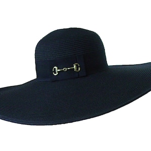 May include: A wide-brimmed black sun hat with a gold-toned metal buckle accent.