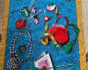 May include: A blue and white tea towel with a lace pattern. The towel features a red purse, a spool of thread, a pair of scissors, a cup of tea, a book with the text "Recettes + Menus", and a red rose. The text "Pour Madame" is printed at the top of the towel.
