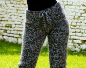May include: Gray fuzzy knit pants with a drawstring waist. The pants are worn by a person standing on a grassy surface.