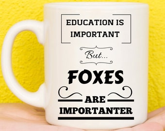 May include: White ceramic mug with black text that reads "Education is important, but... Foxes are importanter".