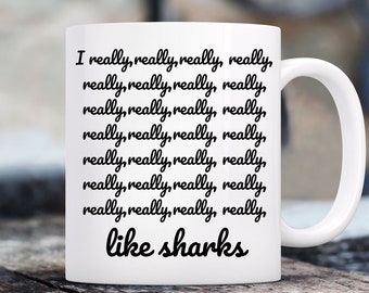 Può includere: Una tazza in ceramica bianca con testo nero che dice "I really, really, really, really, really, really, really, really, really, really, really, really, really, really, really, really, really, really, really, really, like sharks".