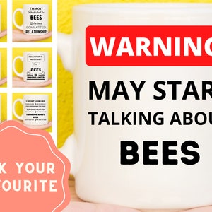 May include: White ceramic mug with black text that reads "WARNING! MAY START TALKING ABOUT BEES". The mug is surrounded by smaller mugs with bee-themed designs and text.