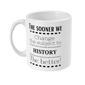 K&ouml;nnte beinhalten: Wei&szlig;e Keramiktasse mit schwarzem Text, der "THE SOONER WE...Change the subject to HISTORY...The better!" lautet.