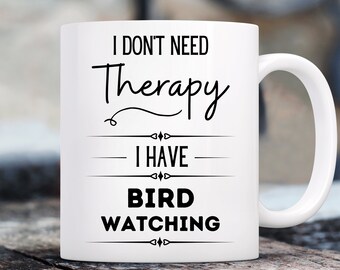May include: White ceramic coffee mug with black text that reads "I don't need therapy I have bird watching".