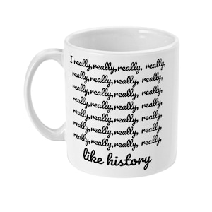 K&ouml;nnte beinhalten: Eine wei&szlig;e Keramiktasse mit schwarzem Text, der "I really, really, really, really, really, really, really, really, really, really, really, really, really, really, really, really, like history" lautet.