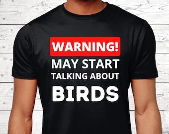 May include: Black t-shirt with white text that reads "WARNING! MAY START TALKING ABOUT BIRDS" with the word "WARNING!" in a red rectangle.