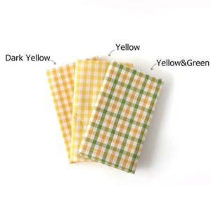 May include: Three folded fabric squares in shades of yellow and green. The fabrics feature a classic gingham pattern. The text labels identify the colors as "Dark Yellow", "Yellow", and "Yellow&Green".