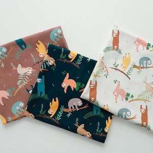 May include: Three fabric swatches with a sloth pattern. The swatches are in shades of brown, teal, and white. The sloths are depicted in various poses, including hanging upside down, sleeping, and eating leaves. The fabric is printed with a white background and features green leaves and branches.