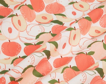 May include: A white fabric with a peach pattern. The peaches are pink and orange and are shown whole and sliced. The fabric has a green leaf pattern.